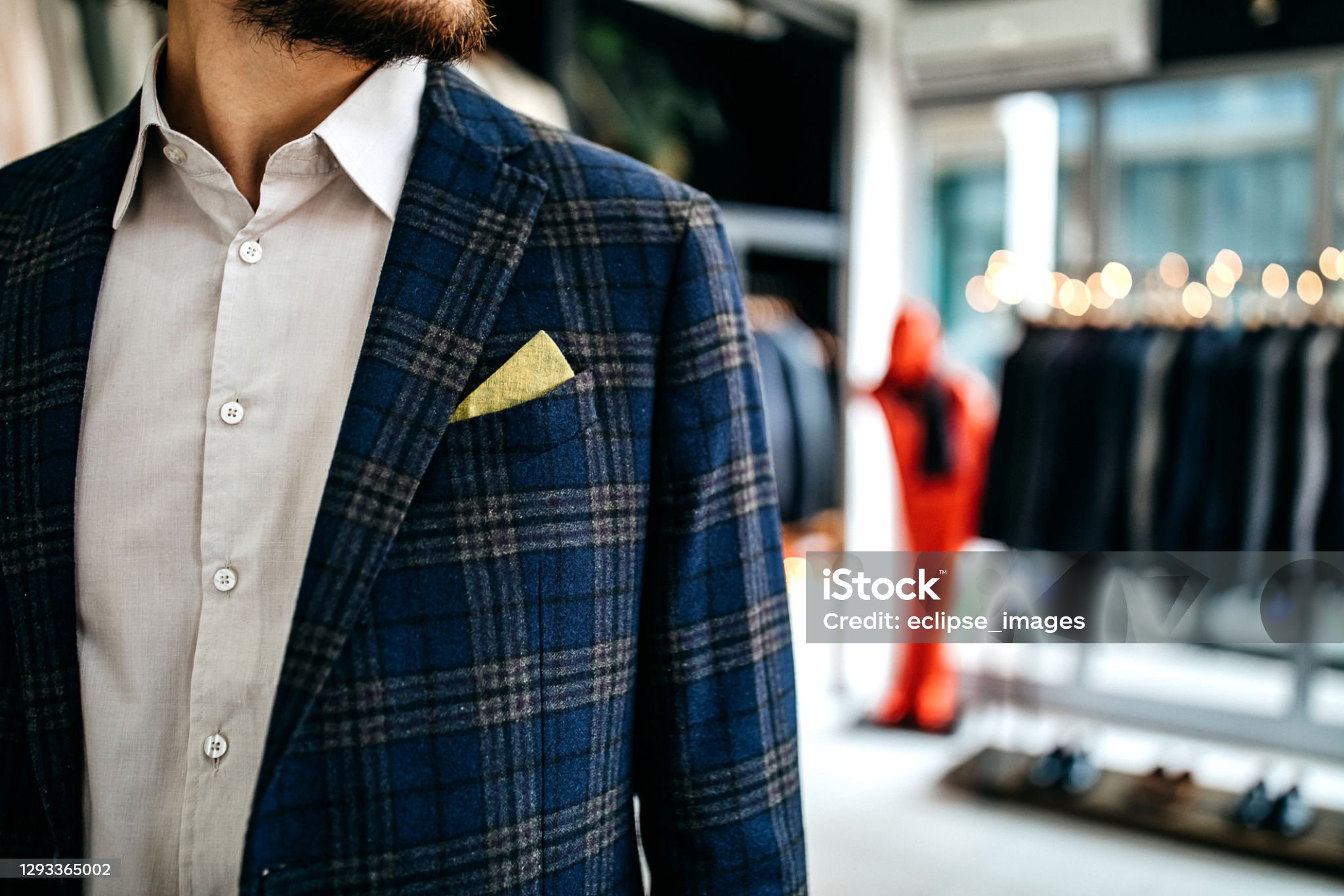 Navy windowpane blazer with yellow pocket square in a boutique